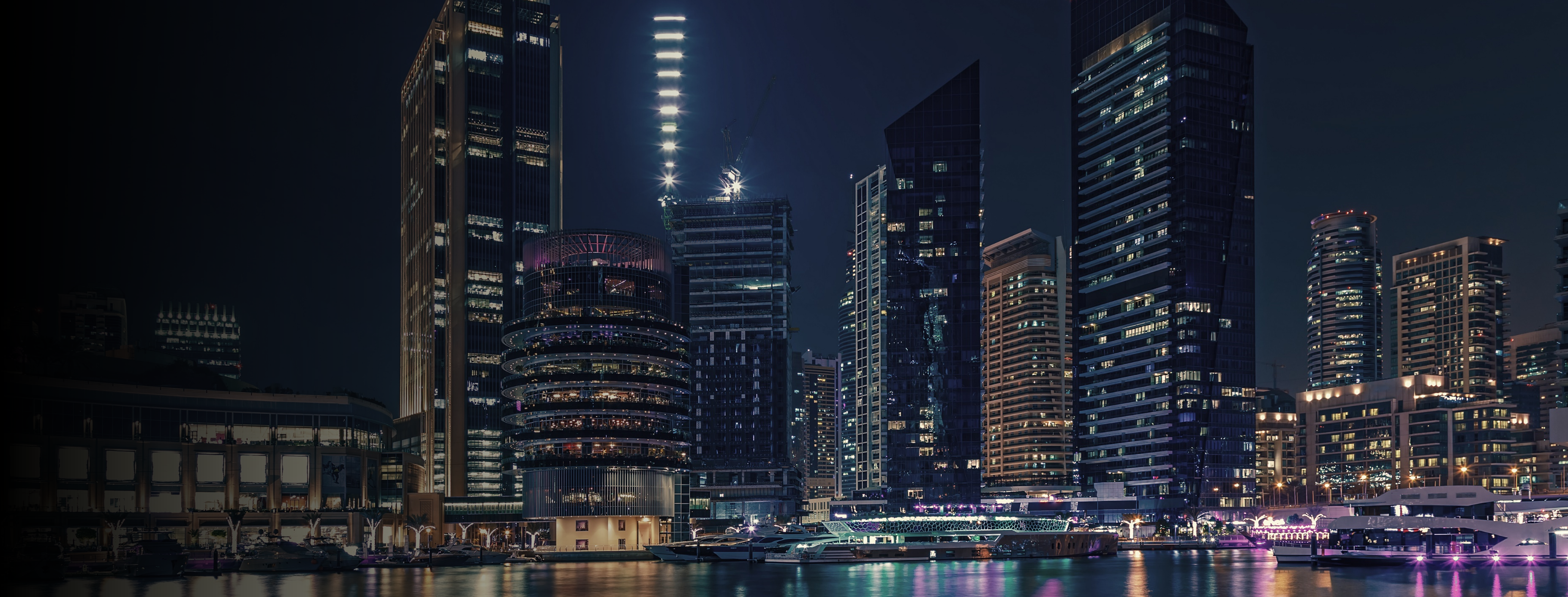 Skyline de uma cidade com luzes refletindo na água